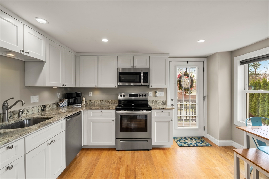 10 Cedar Street Hudson, MA 01749 - Photo 3 of 38 a kitchen with granite countertop a stove and a sink