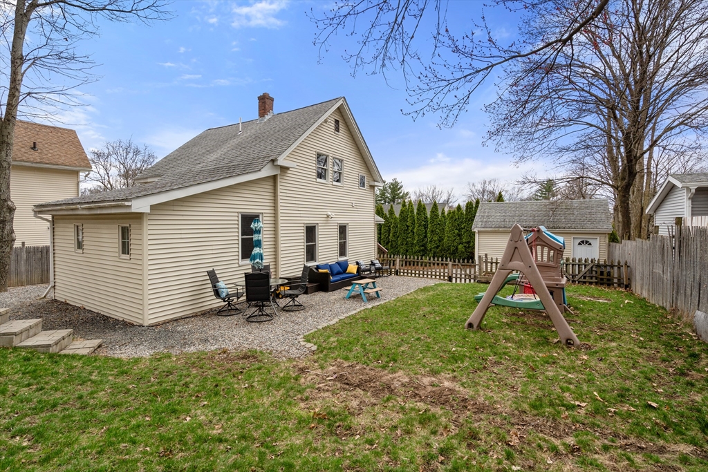 10 Cedar Street Hudson, MA 01749 - Photo 34 of 38 a view of a backyard with a table and chairs