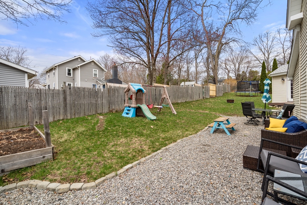 10 Cedar Street Hudson, MA 01749 - Photo 36 of 38 a view of a backyard with a garden and a tree