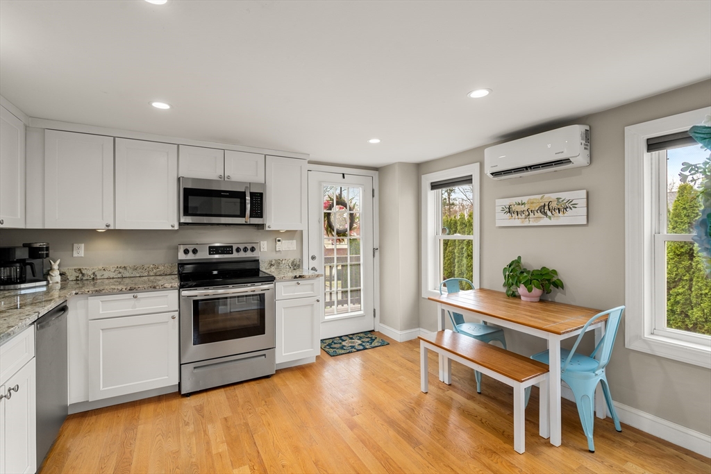 10 Cedar Street Hudson, MA 01749 - Photo 6 of 38 a kitchen with stainless steel appliances kitchen island granite countertop a stove a sink and a microwave