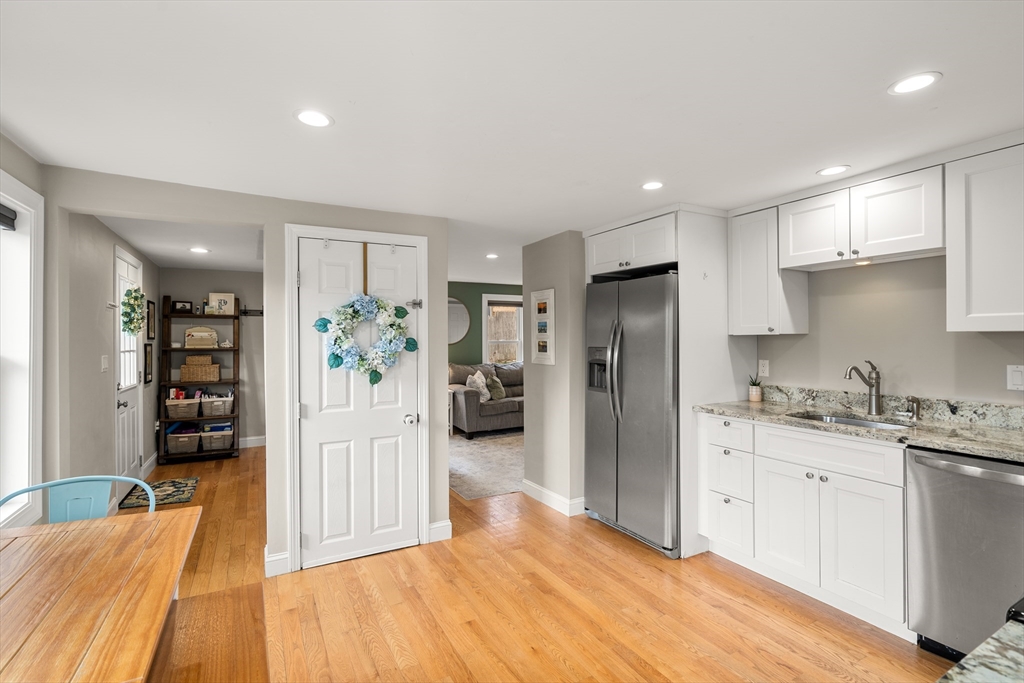 10 Cedar Street Hudson, MA 01749 - Photo 7 of 38 a kitchen with stainless steel appliances kitchen island granite countertop a refrigerator and cabinets