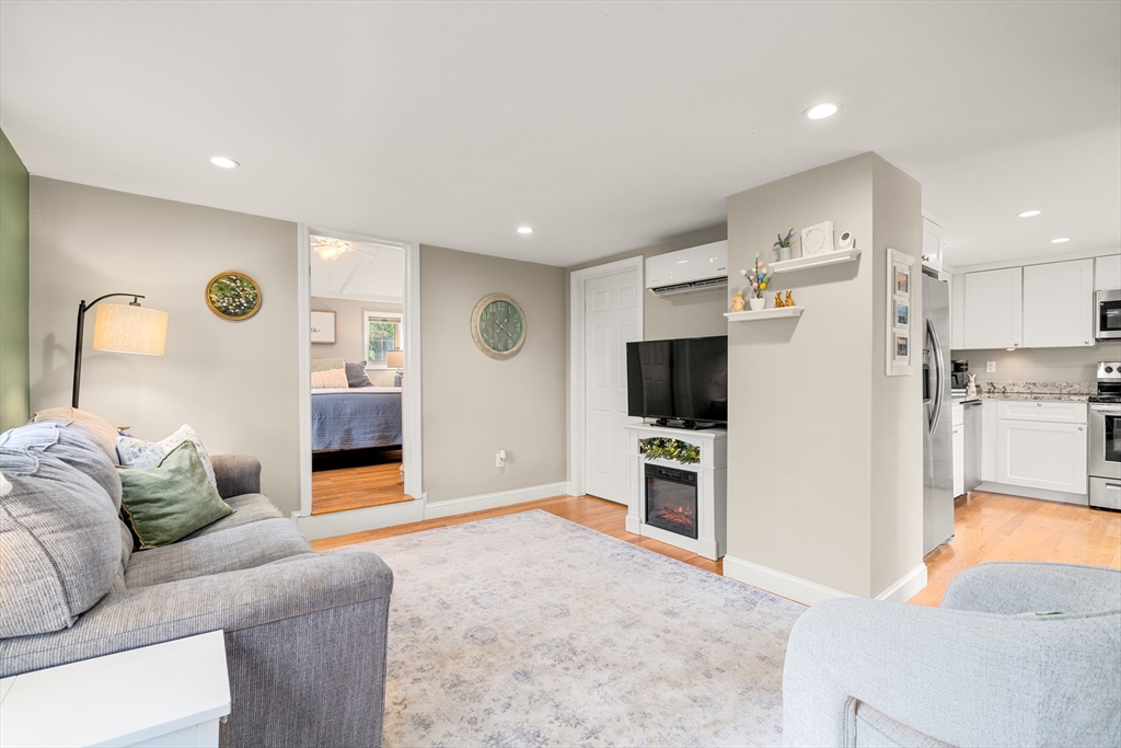 10 Cedar Street Hudson, MA 01749 - Photo 9 of 38 a living room with furniture and a flat screen tv
