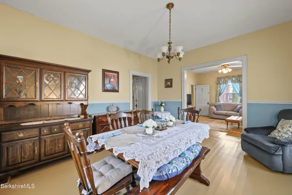 a view of a dining room with furniture and a chandelier