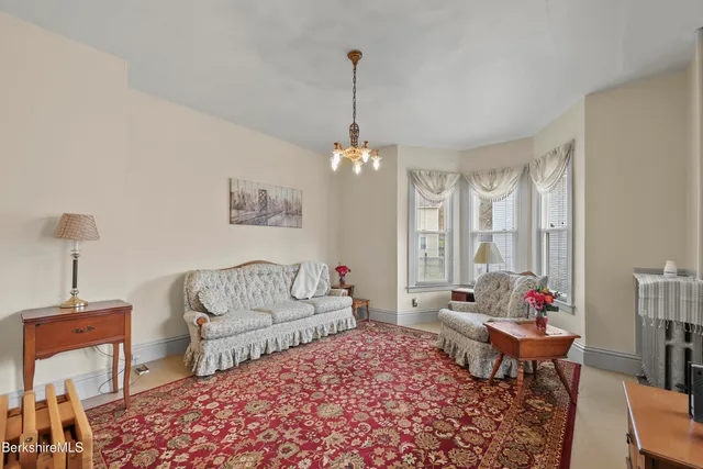 a living room with furniture and a chandelier