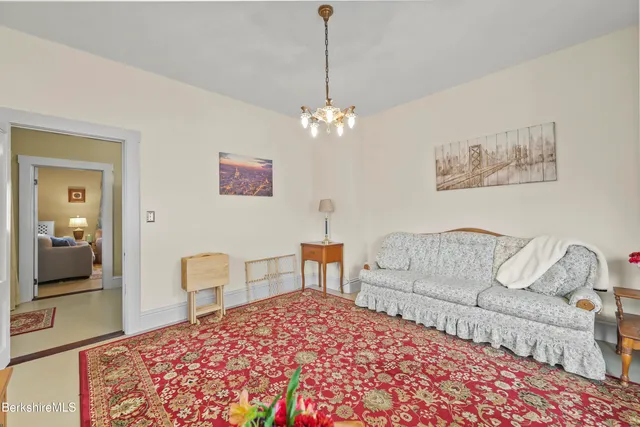 a bedroom with a large bed and a chandelier