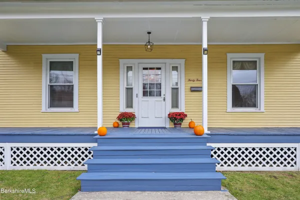 a front view of a house with a garden