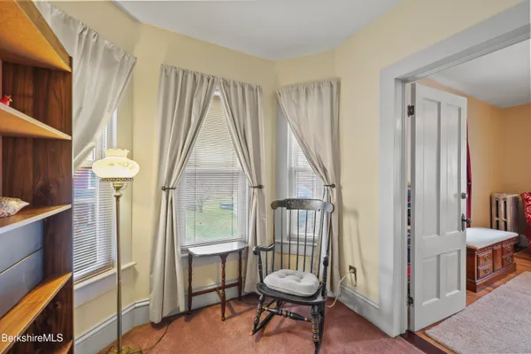 a view of a room with wooden floor and chair