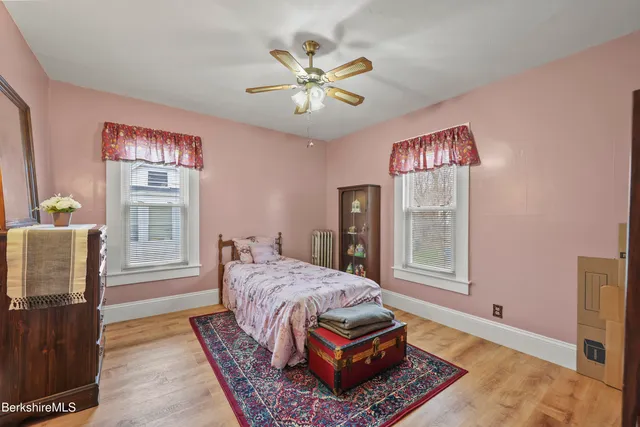 a living room with furniture a bed and a window