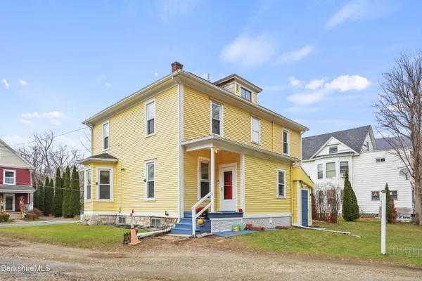 a front view of a house with a yard