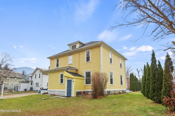 a front view of a house with a yard
