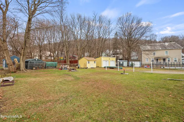 a view of yard with swimming pool and trees