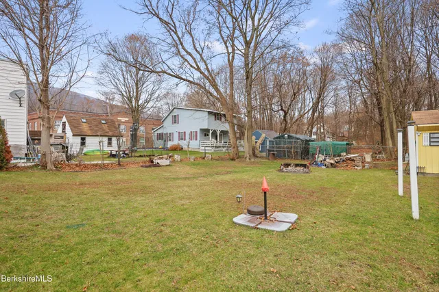 a swimming pool with outdoor seating and trees