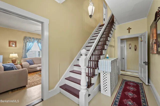 a living room with furniture and stairs