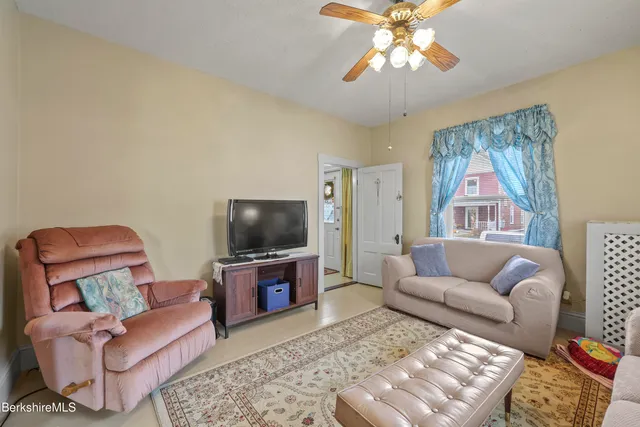 a living room with furniture and a flat screen tv