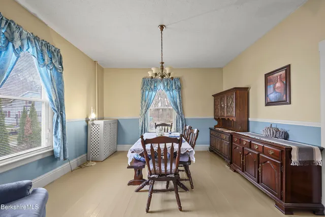 a dining room with furniture and window
