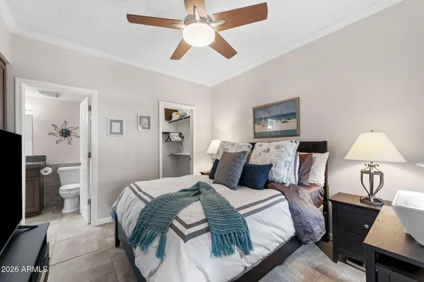 a bedroom with a bed and a chandelier