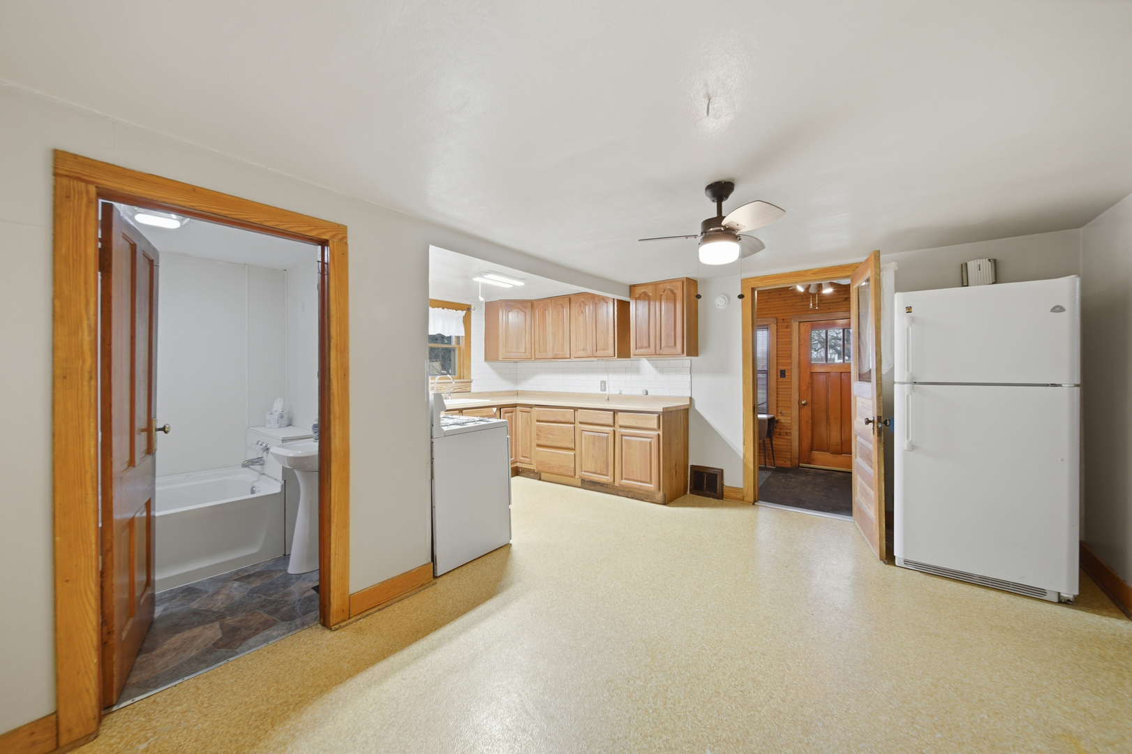 599 Palmyra Road Dixon, IL 61021 - Photo 11 of 34 a view of a kitchen with refrigerator and white cabinets