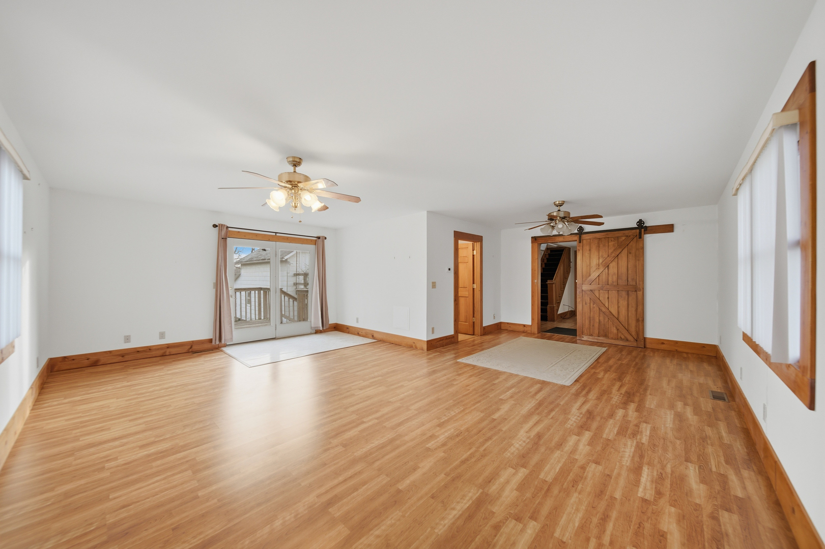 599 Palmyra Road Dixon, IL 61021 - Photo 12 of 34 an empty room with wooden floor cabinet and windows