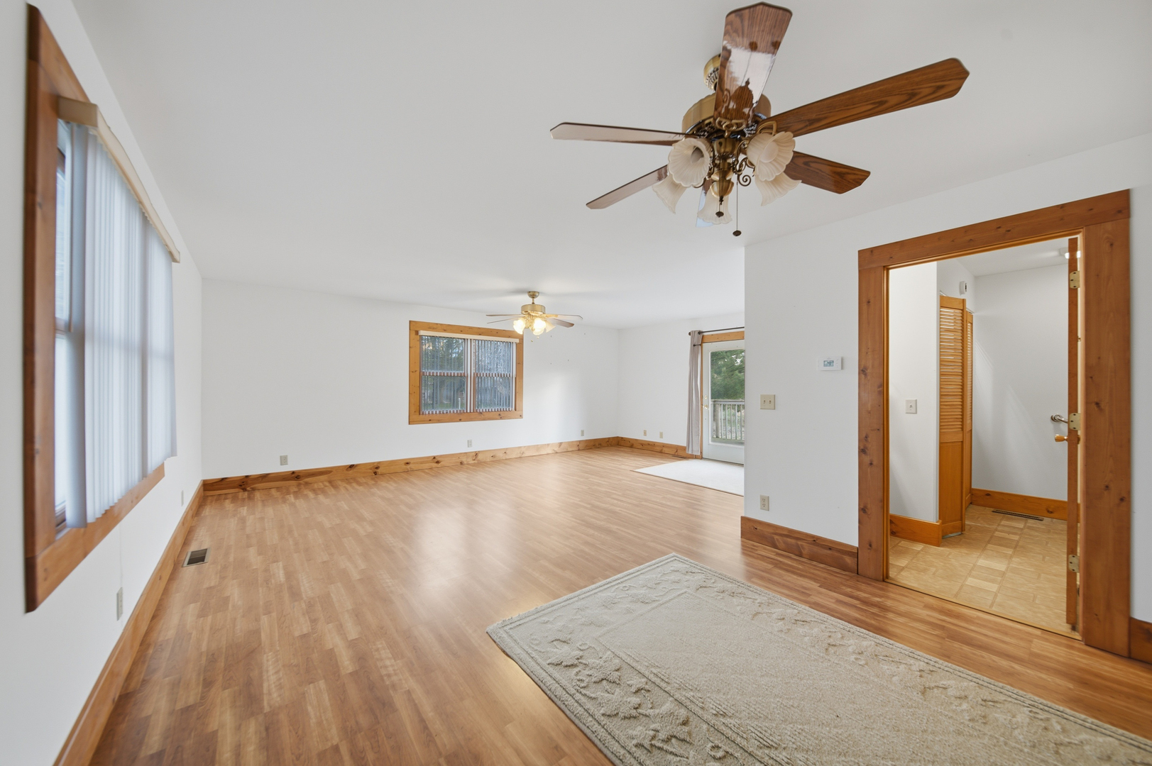 599 Palmyra Road Dixon, IL 61021 - Photo 13 of 34 an empty room with wooden floor fan and windows