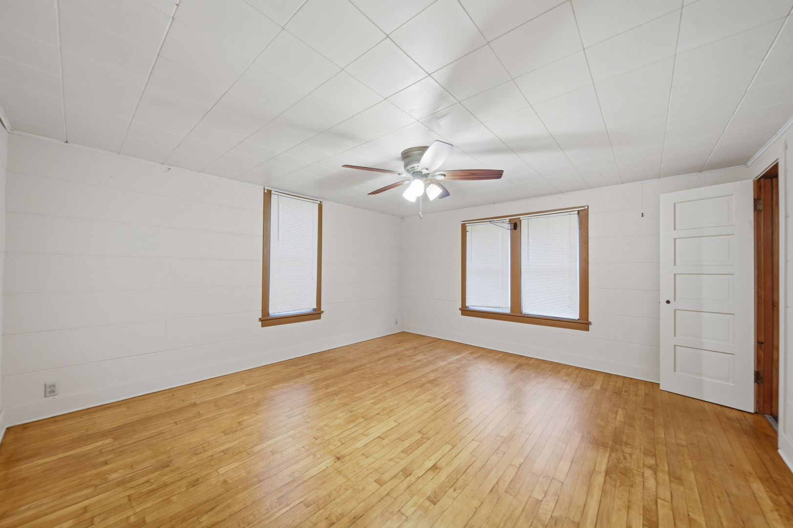 599 Palmyra Road Dixon, IL 61021 - Photo 16 of 34 a view of an empty room with wooden floor and a window