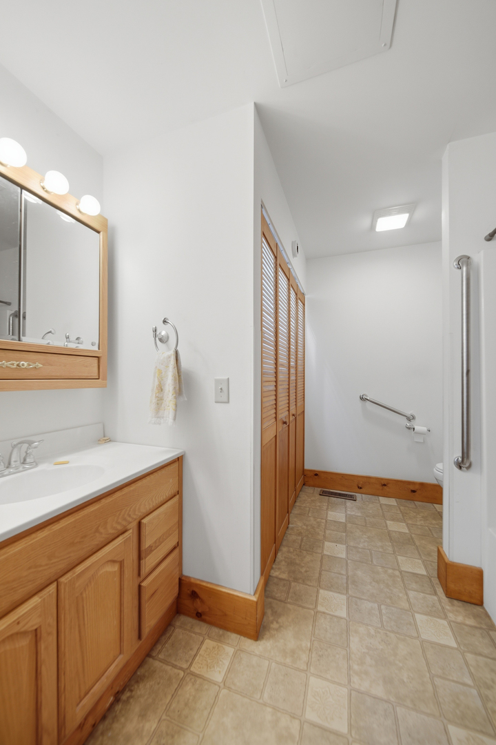 599 Palmyra Road Dixon, IL 61021 - Photo 17 of 34 a bathroom with a sink a mirror and a shower