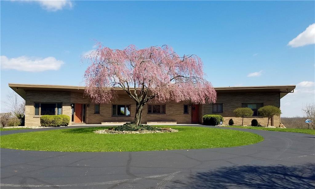 131 East Airport Road Butler, PA 16002 - Photo 1 of 25 a front view of a building with garden and trees