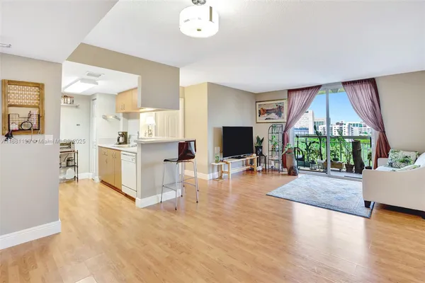 a living room with furniture a flat screen tv and a large window