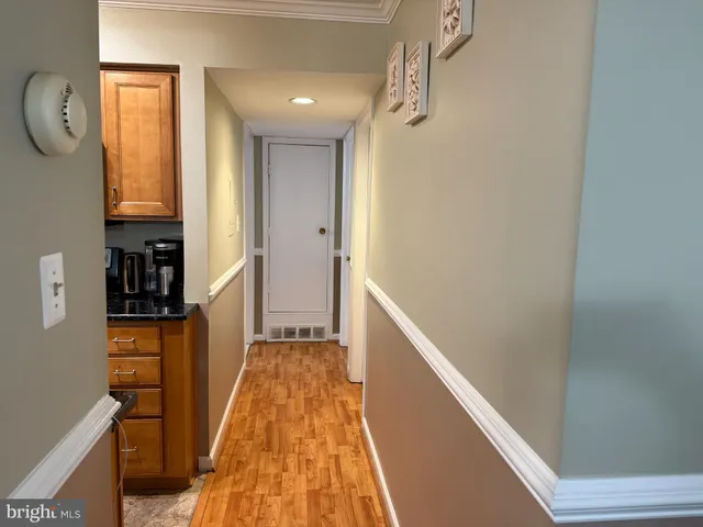 a view of hallway with wooden floor