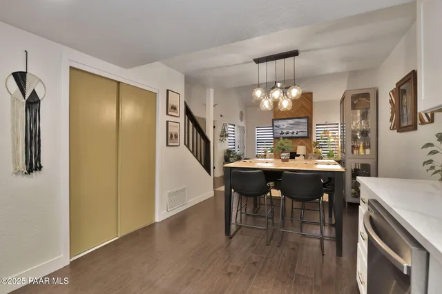 a view of a dining room with furniture and chandelier