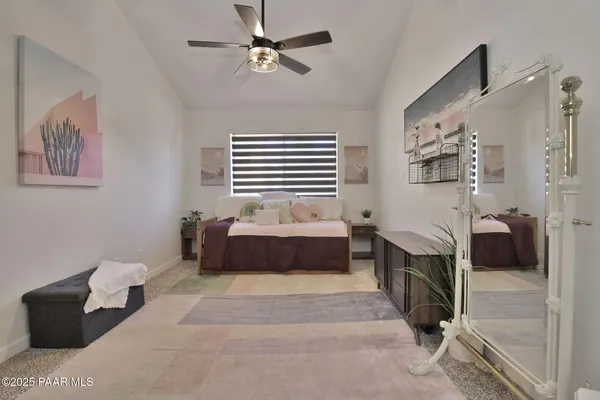 a spacious bedroom with a bed and a chandelier