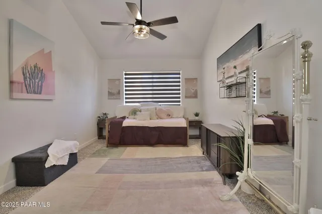 a spacious bedroom with a bed and a chandelier