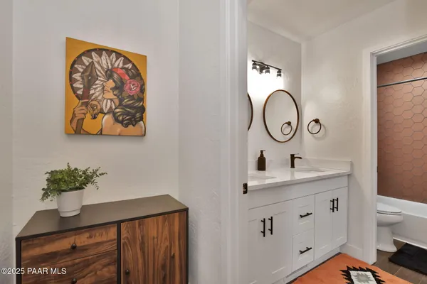 a view of bathroom with a sink and a mirror