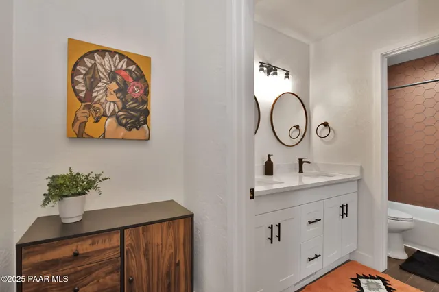 a view of bathroom with a sink and a mirror