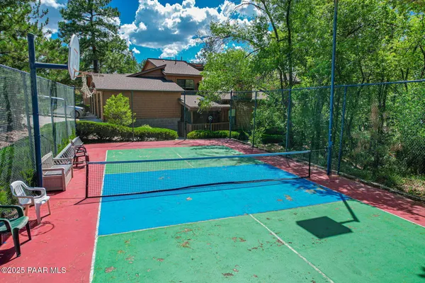 a green field with lots of trees in the background