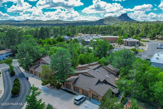 an aerial view of a house with a garden and outdoor seating