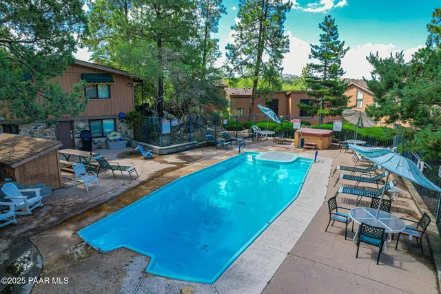a view of a swimming pool with lounge chairs in patio