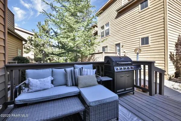 a view of roof deck with wooden floor and seating space