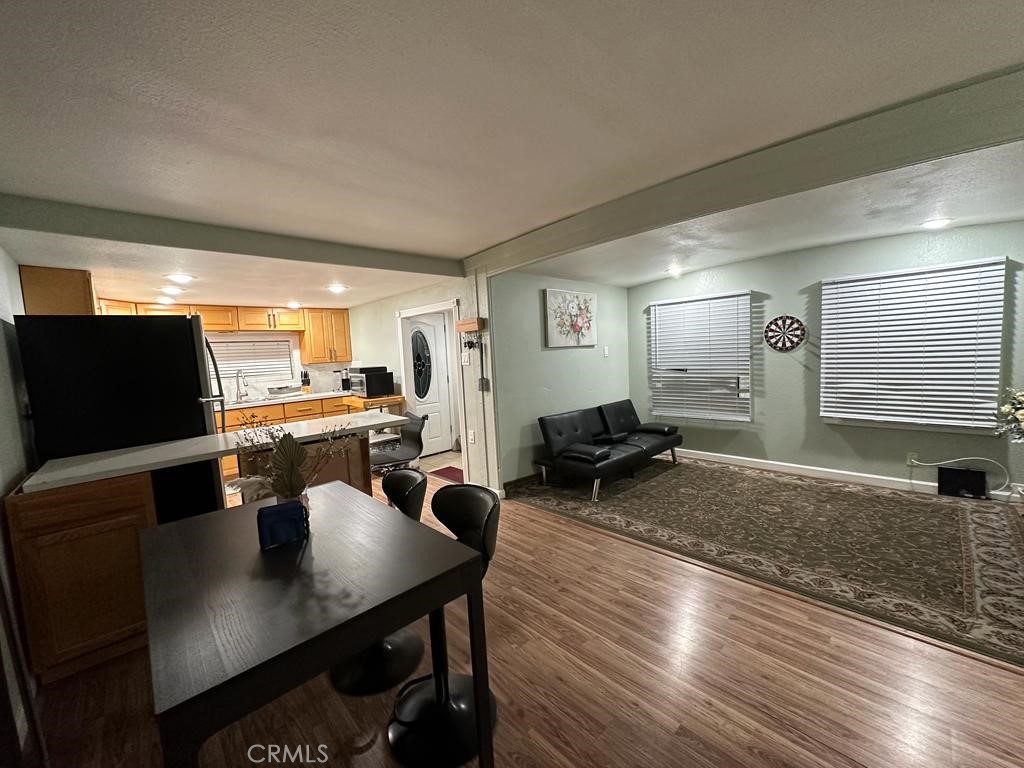 5751 Bridgehead Road, Unit 38 Oakley, CA 94561 - Photo 3 of 17 a living room with furniture a flat screen tv and kitchen view