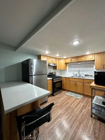 a kitchen with a refrigerator and a stove top oven