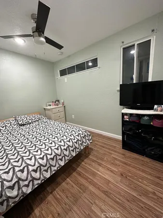 a bedroom with a bed and window