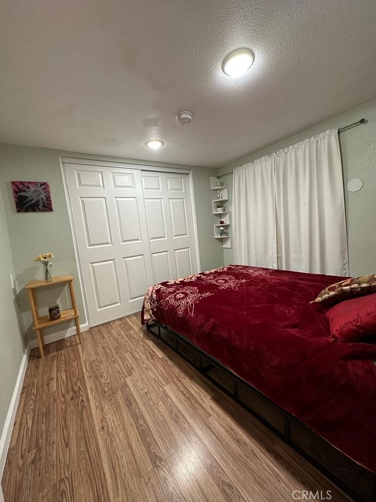 5751 Bridgehead Road, Unit 38 Oakley, CA 94561 - Photo 10 of 17 a spacious bedroom with a bed and wooden floor