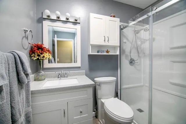 a bathroom with a sink toilet and shower