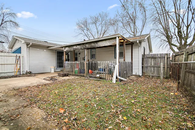 a view of a house with a yard and garage