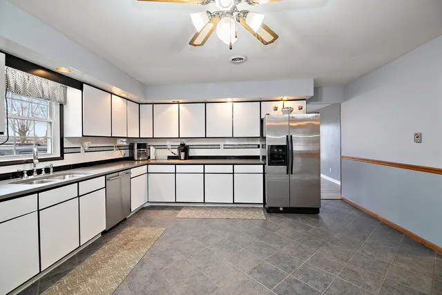 a kitchen with stainless steel appliances a refrigerator sink and cabinets