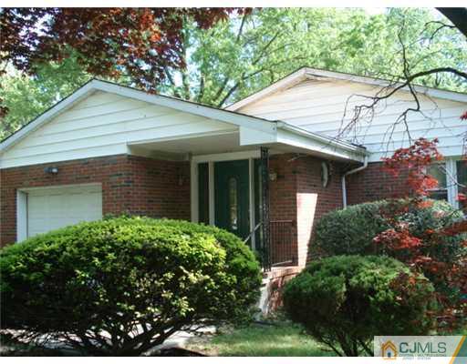 2031 Oak Tree Road Edison, NJ 08820 - Photo 1 of 12 a front view of a house with a garden