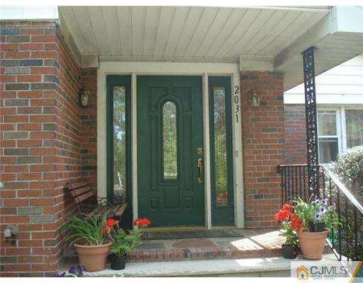 2031 Oak Tree Road Edison, NJ 08820 - Photo 2 of 12 a front view of a house with potted plants