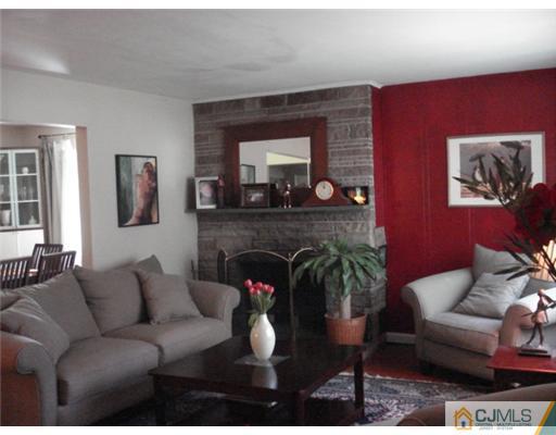 2031 Oak Tree Road Edison, NJ 08820 - Photo 3 of 12 a living room with furniture and a fireplace