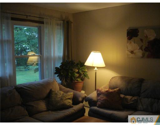 2031 Oak Tree Road Edison, NJ 08820 - Photo 10 of 12 a living room with furniture and a lamp