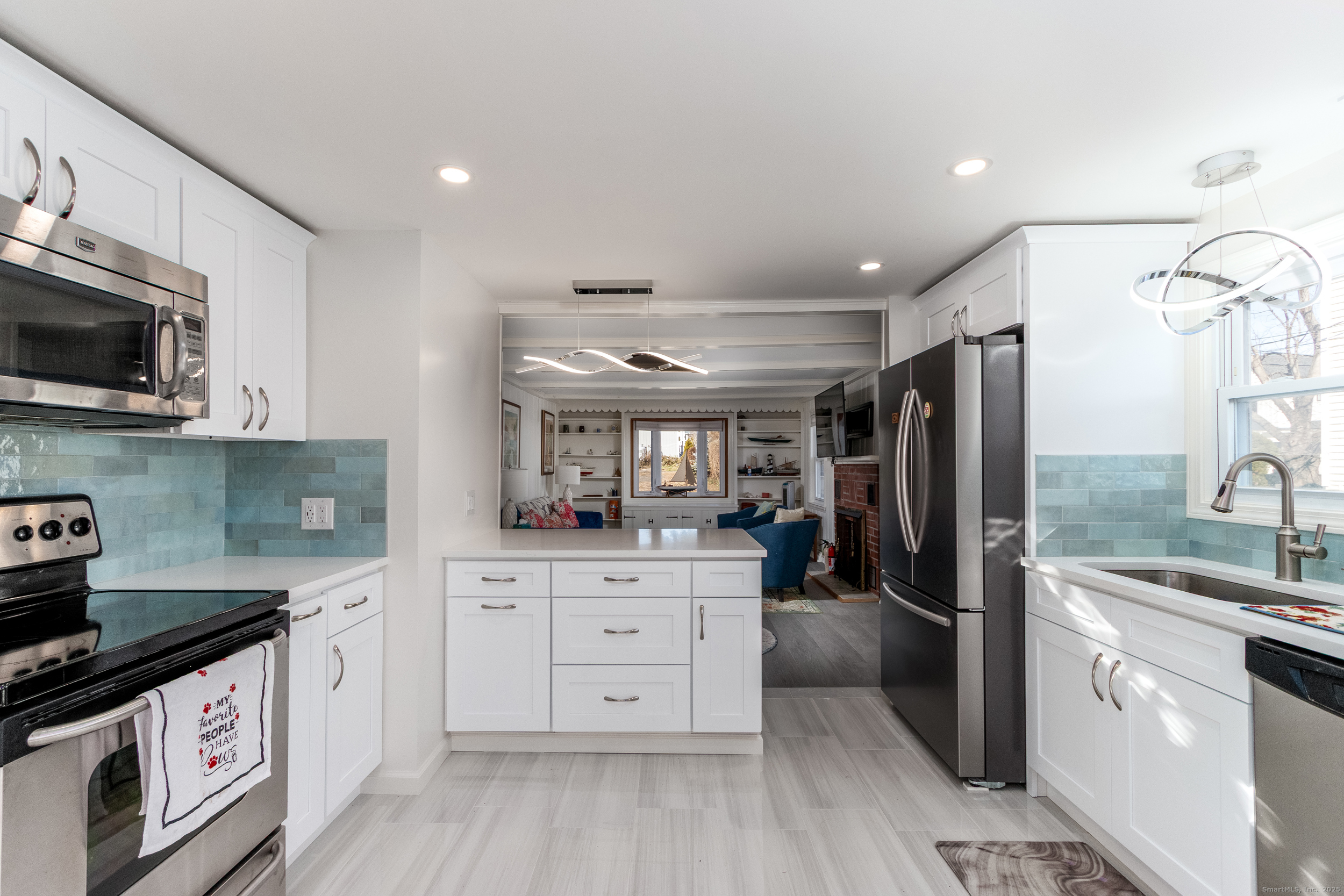 18 Bay Street Guilford, CT 06437 - Photo 11 of 34 a kitchen with stainless steel appliances a stove refrigerator sink and microwave