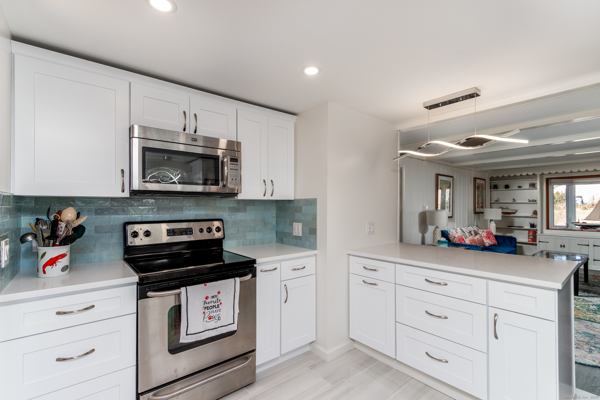 18 Bay Street Guilford, CT 06437 - Photo 12 of 34 a kitchen with white cabinets stainless steel appliances and sink